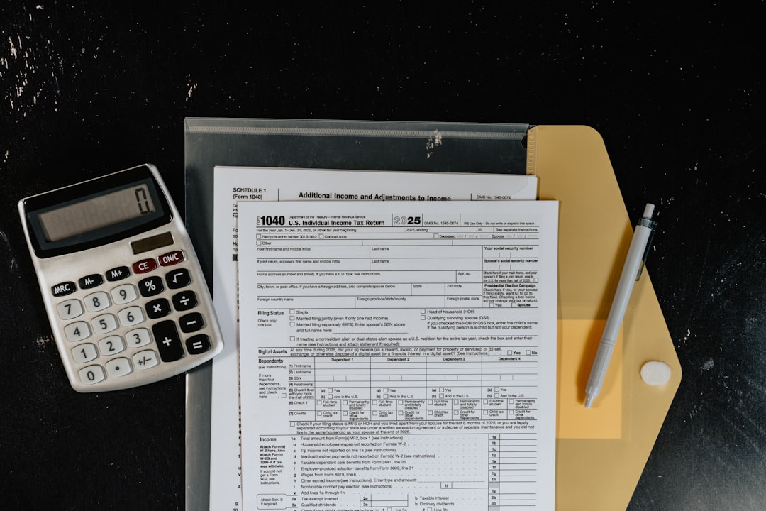 calculator-and-tax-forms-on-a-dark-surface-x2soehdvkly